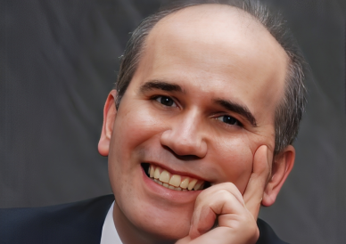 A man with a bald head smiling for the camera.
