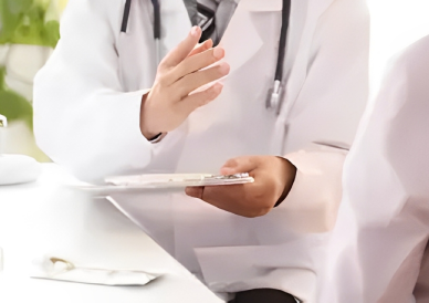 A doctor is holding his hands up while talking to someone.