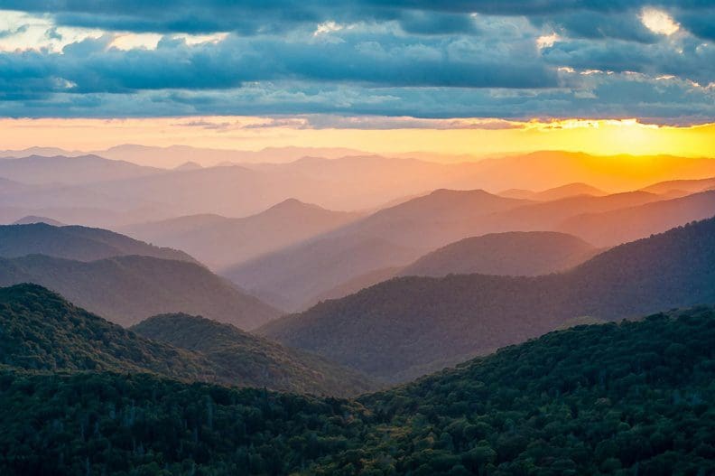 A view of the mountains at sunset from atop a mountain