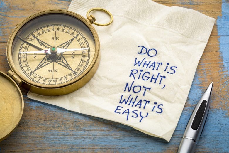 A compass and pen on top of a napkin