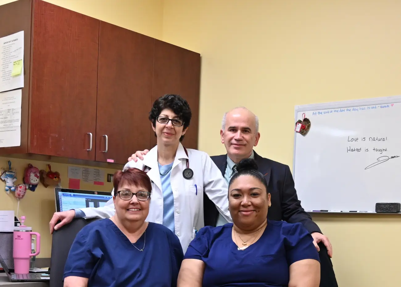 A group of doctors and nurses posing for the camera.